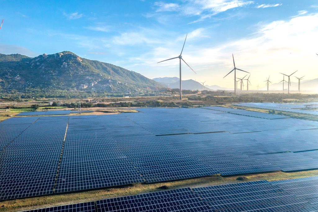 pexels-photo-35105437-35105437 Aerial view of a solar and wind energy farm set against Vietnam's scenic landscape.